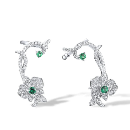 Floral vine-inspired earrings with sparkling white pavé and green gemstone accents

