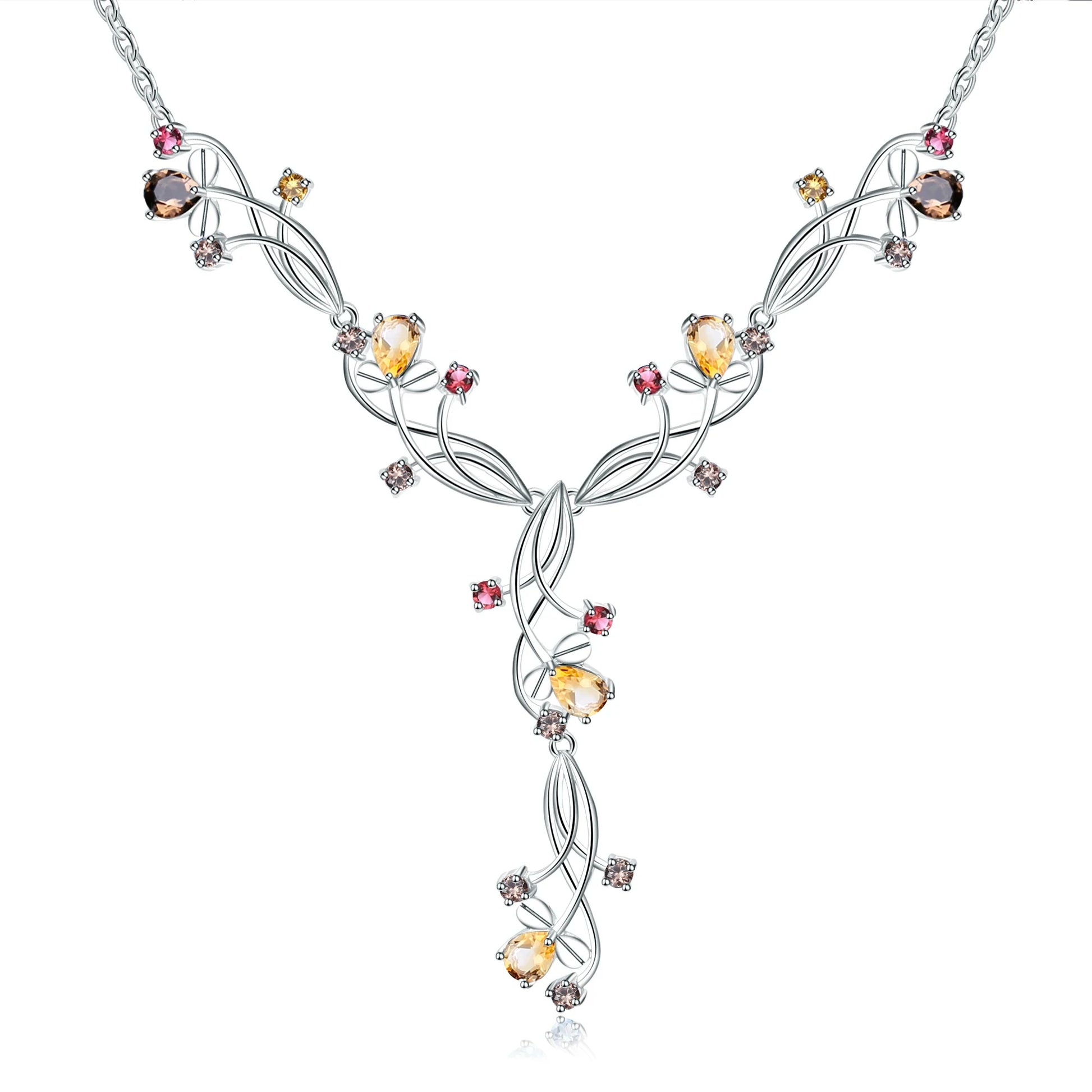 Silver necklace with an intricate swirling design, adorned with multicolored gemstones in pink, yellow, brown, and clear tones.


