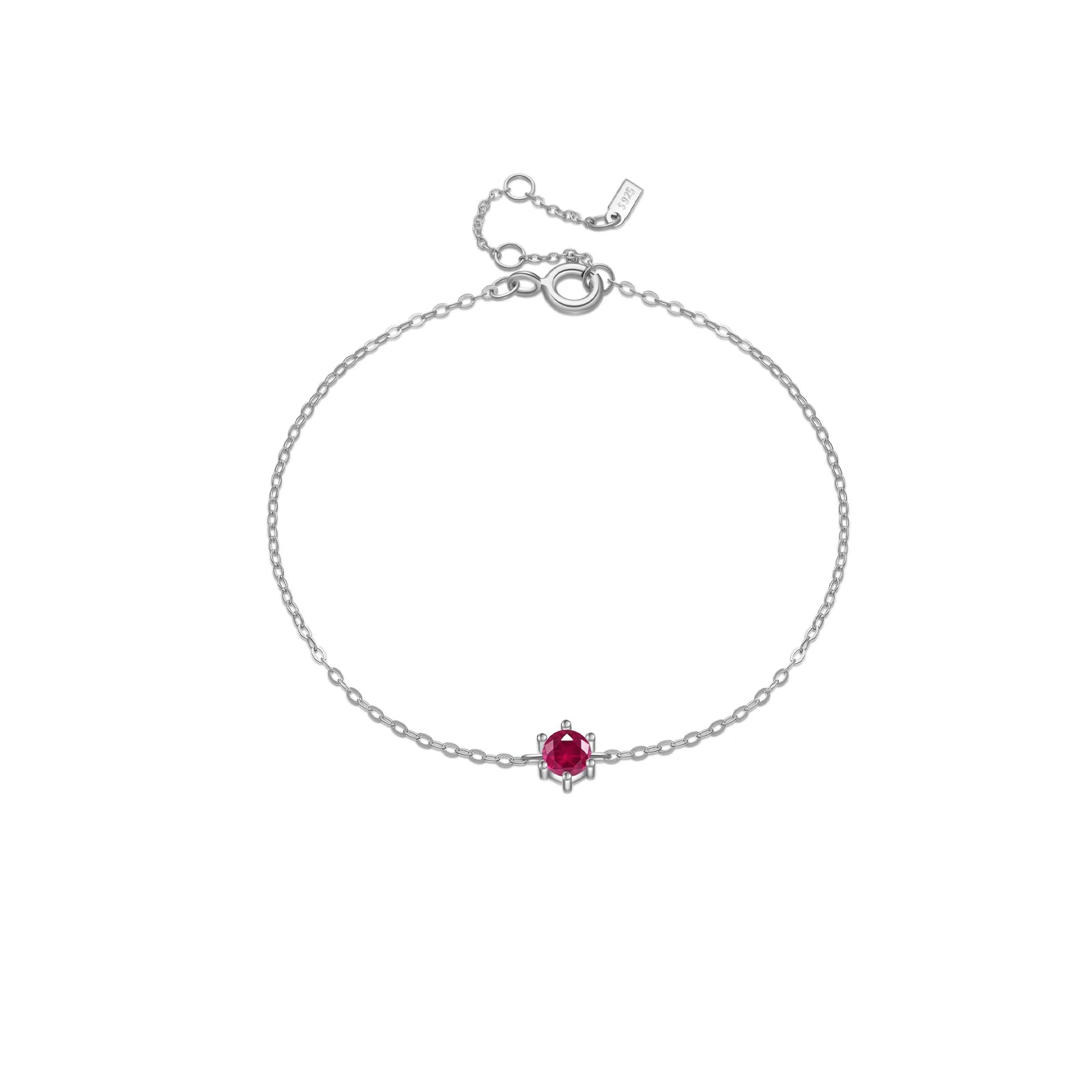 Delicate silver bracelet featuring a single round red stone set at the center.

