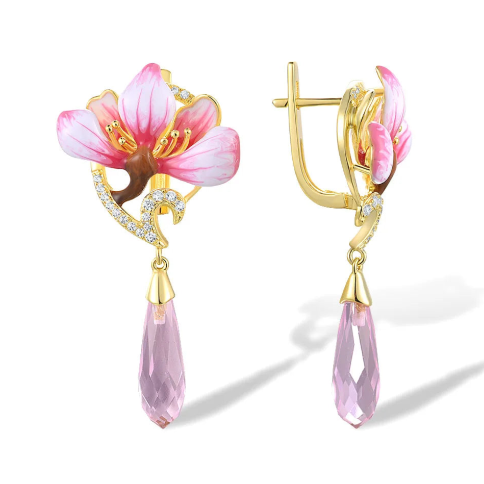 Lampadario earrings with pink enamel flower tops, gold detailing, and faceted pink teardrop dangles.

