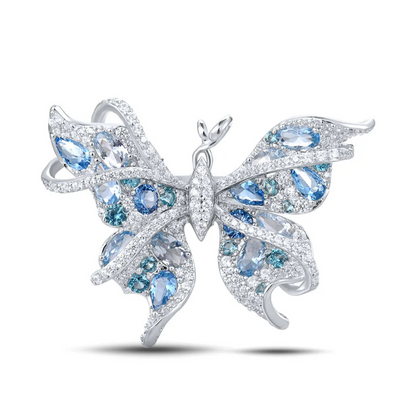 Silver butterfly-shaped ring with shimmering light blue and aqua gemstones set in detailed wing patterns

