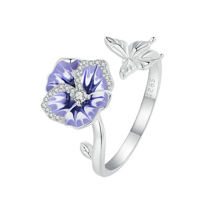 Sterling silver wrap ring featuring one delicate purple and white enamel flowers with clear center stones and leaf details.


