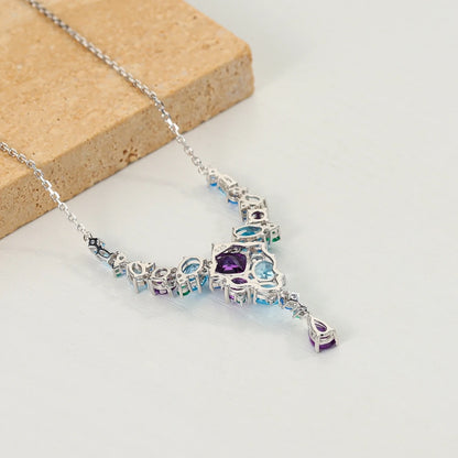 Necklace with gradient blue and green gemstones arranged in an organic cascading pattern

