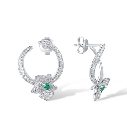 Silver stud earrings with open circle design, pavé stones, and green gemstone floral accents

