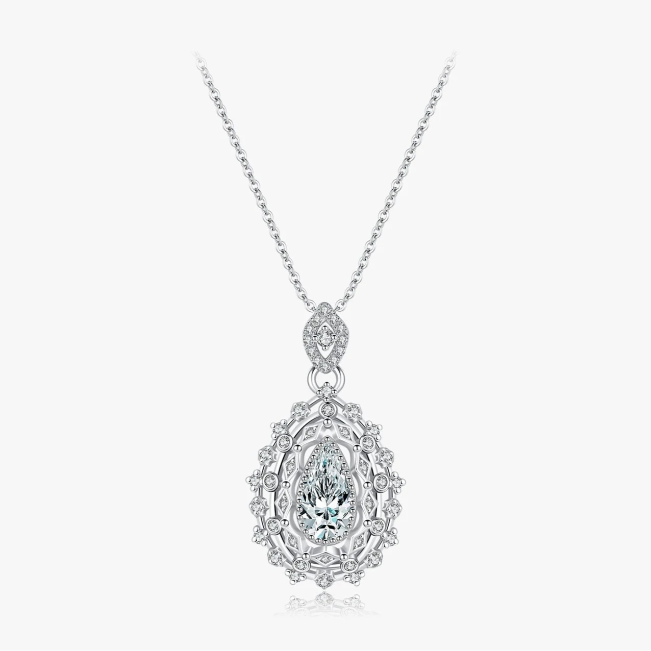 Ornate silver necklace with an intricate teardrop pendant, featuring a central pear-cut white gemstone, part of the Bianco Nero collection.

