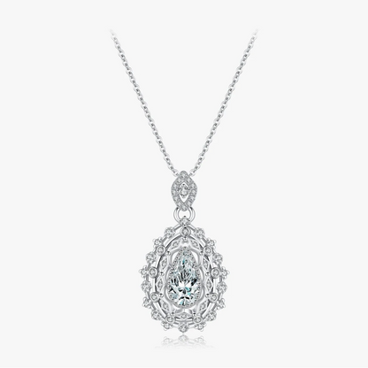 Ornate silver necklace with an intricate teardrop pendant, featuring a central pear-cut white gemstone, part of the Bianco Nero collection.

