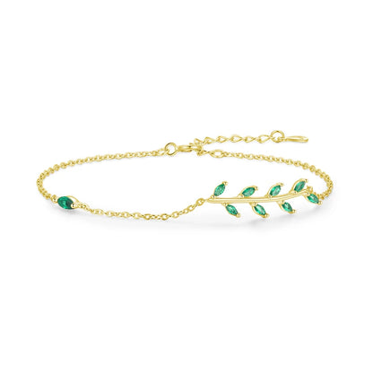 Gold chain bracelet with a delicate green leaf branch design.

