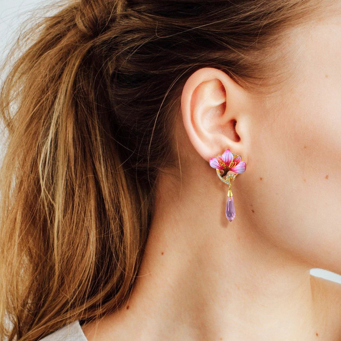 Lampadario earrings with pink enamel flower tops, gold detailing, and faceted pink teardrop dangles.


