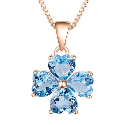Silver pendant featuring four heart-cut light blue stones arranged in a floral shape

