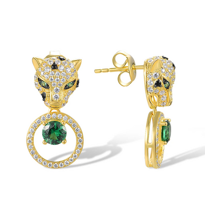 Gold earrings with panther head design, sparkling black and white stones, and green gemstone drop in circular setting

