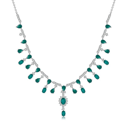 A silver necklace featuring green garnet stones set in an oval pattern with additional small white stones on a link chain.
