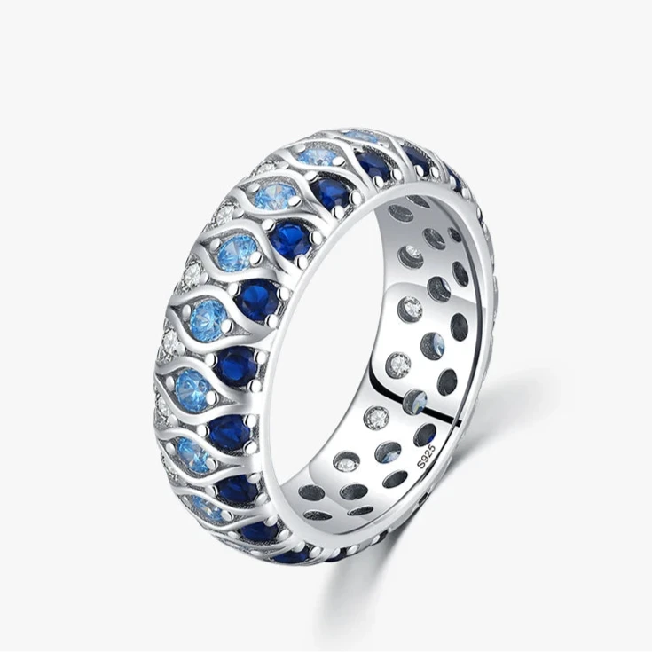 Sterling silver eternity band with alternating light and dark blue stones in a woven design

