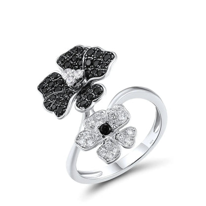 Sterling silver open ring with black and white crystal-studded flowers, part of the Rosa Nera collection.

