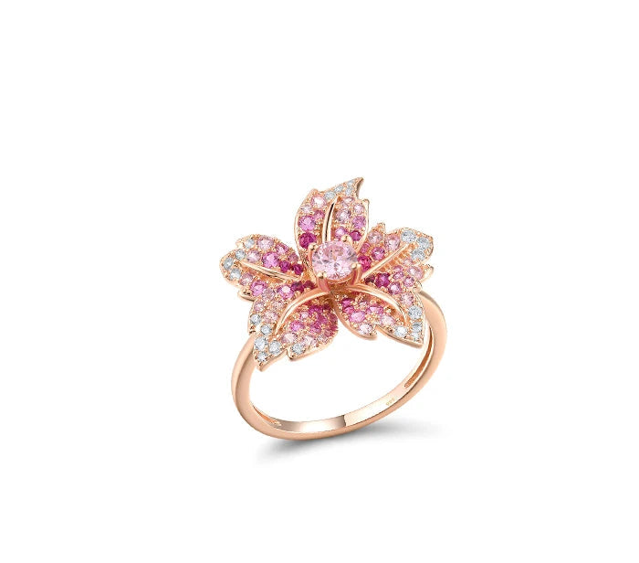 Giglio Rosa jewelry set featuring flower-shaped rose gold pieces with pink and white pavé stones, including ring, earrings, and pendant.

