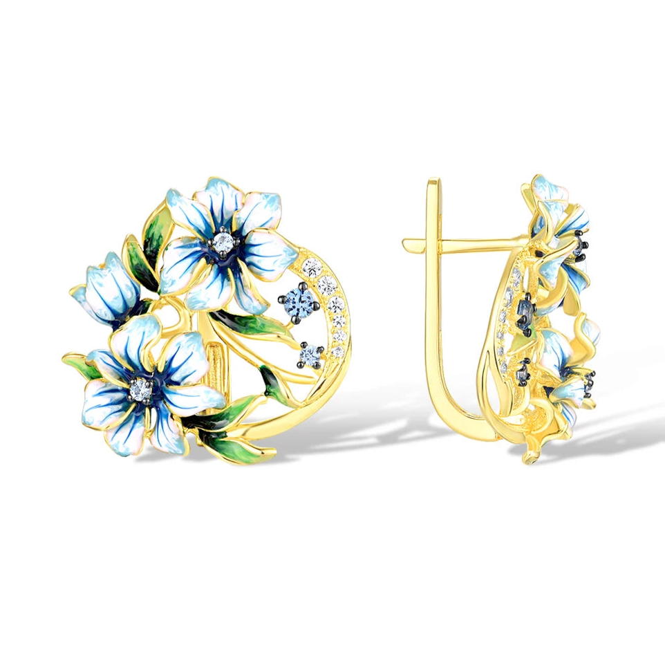 Gold-tone earrings with white and blue enamel flowers and crystal accents

