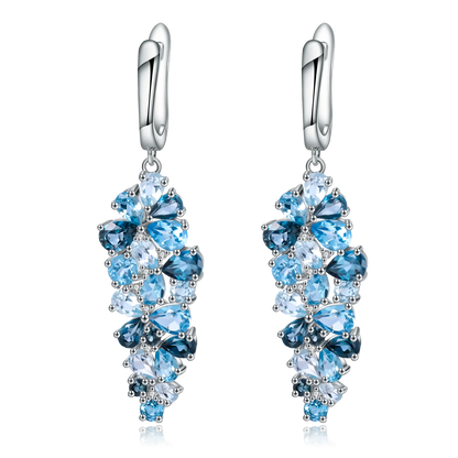 Silver drop earrings with clusters of marquise and pear-cut blue gemstones in varying shades

