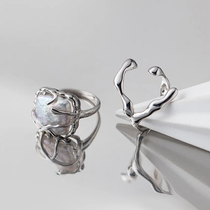Sterling silver ring featuring a baroque freshwater pearl encased in an abstract organic claw setting

