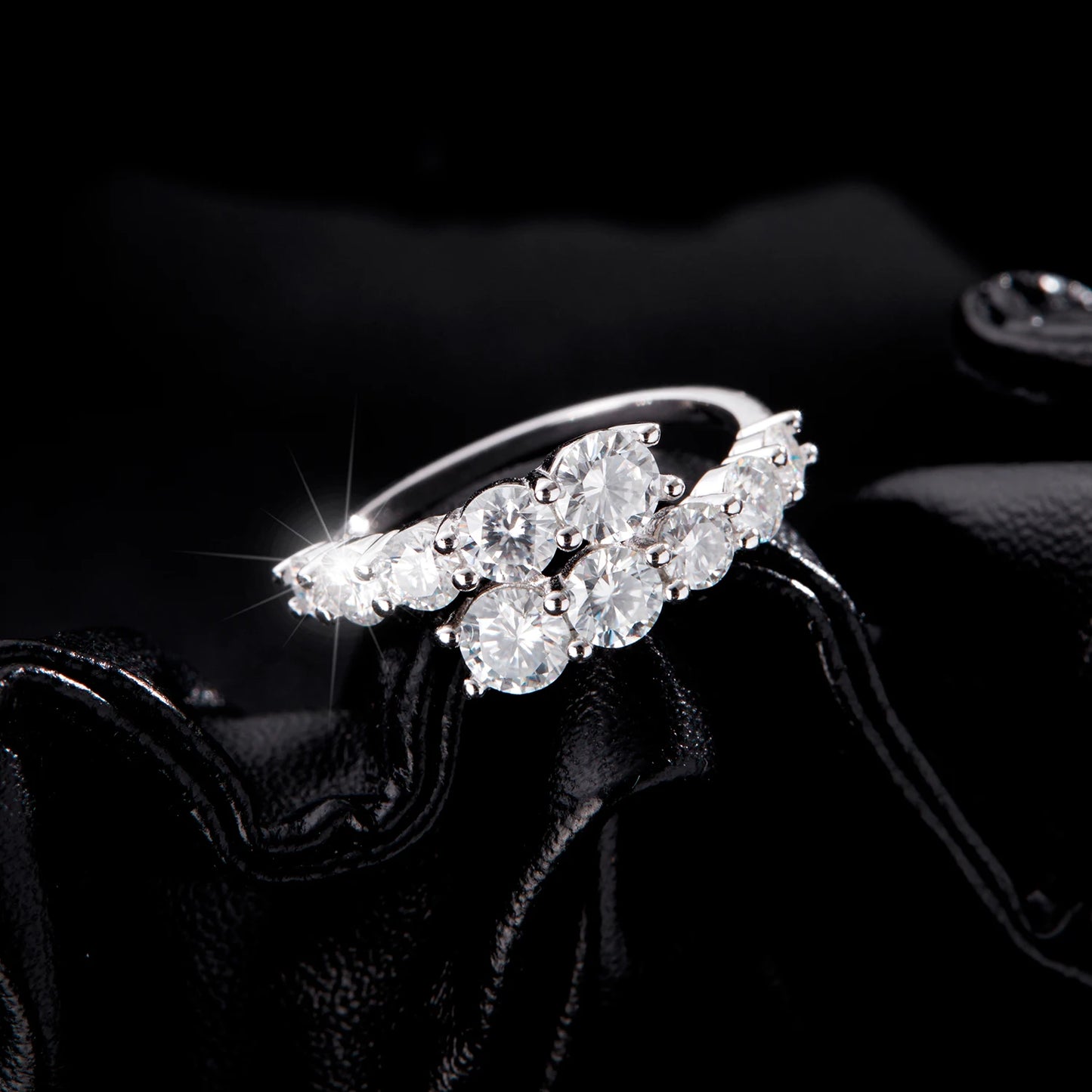 Sterling silver ring with a diagonal cluster of brilliant white round-cut stones in a cascading arrangement

