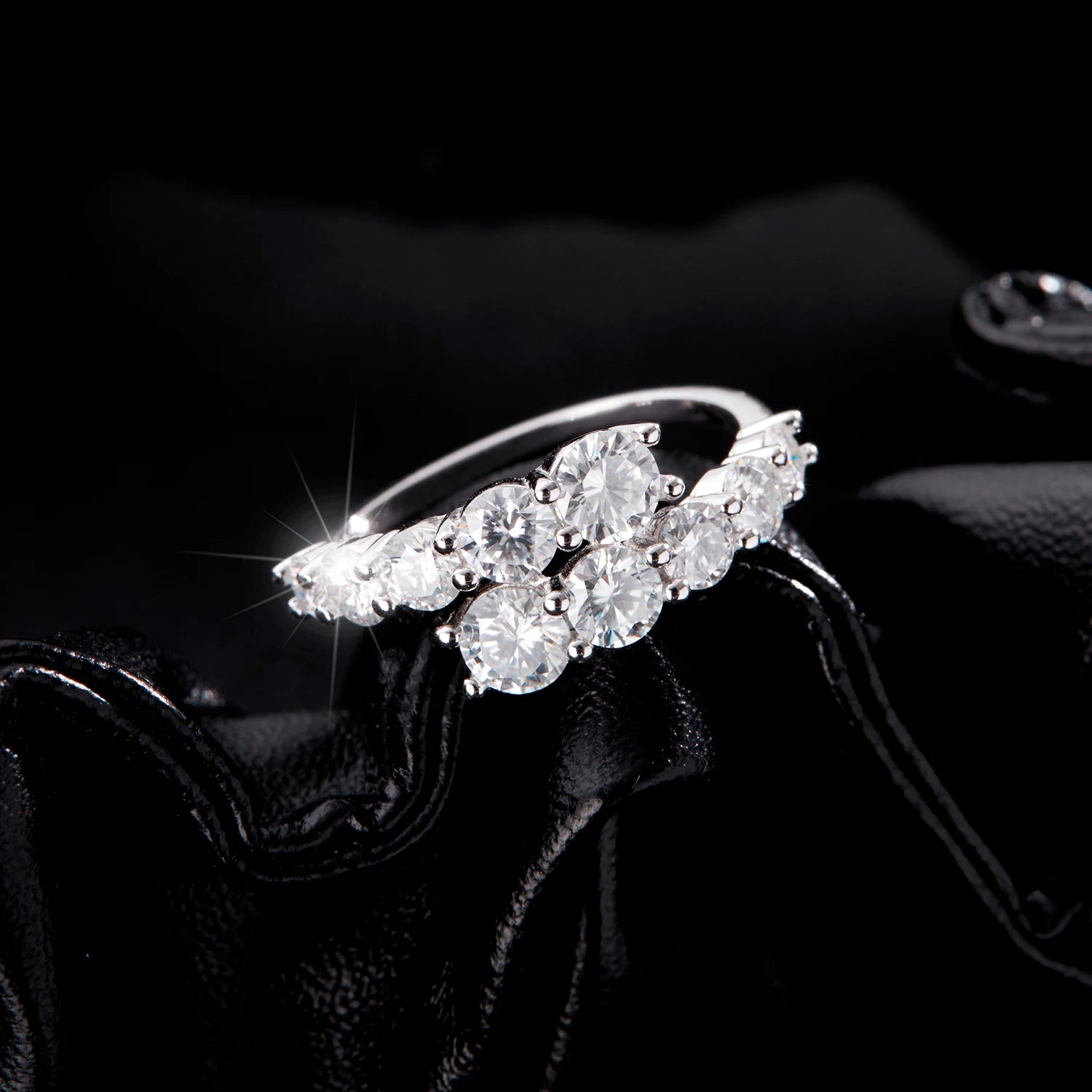 Sterling silver ring with a diagonal cluster of brilliant white round-cut stones in a cascading arrangement


