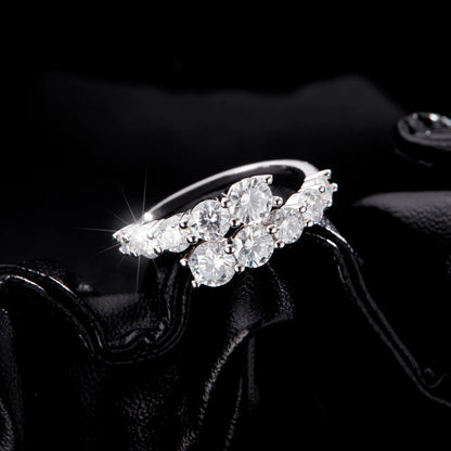 Sterling silver ring with a diagonal cluster of brilliant white round-cut stones in a cascading arrangement

