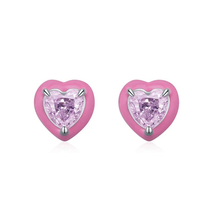 Stud earrings shaped like soft pink hearts, each set with a sparkling light pink heart-cut gemstone.

