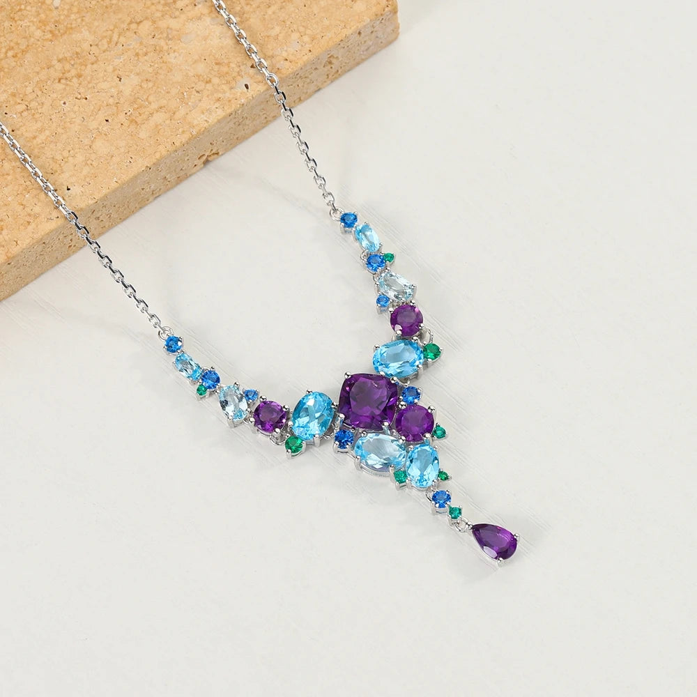 Necklace with gradient blue and green gemstones arranged in an organic cascading pattern

