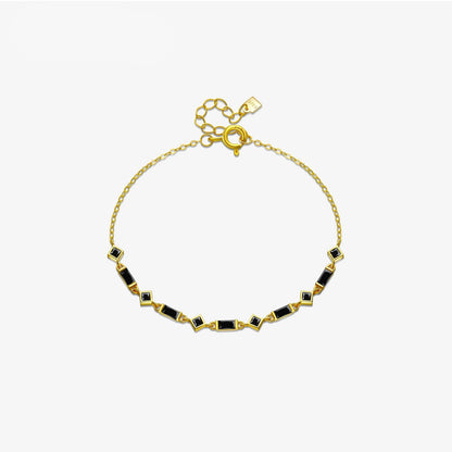 Silver bracelet with alternating square and rectangular black stones on a fine chain, from the Vindemia line.

