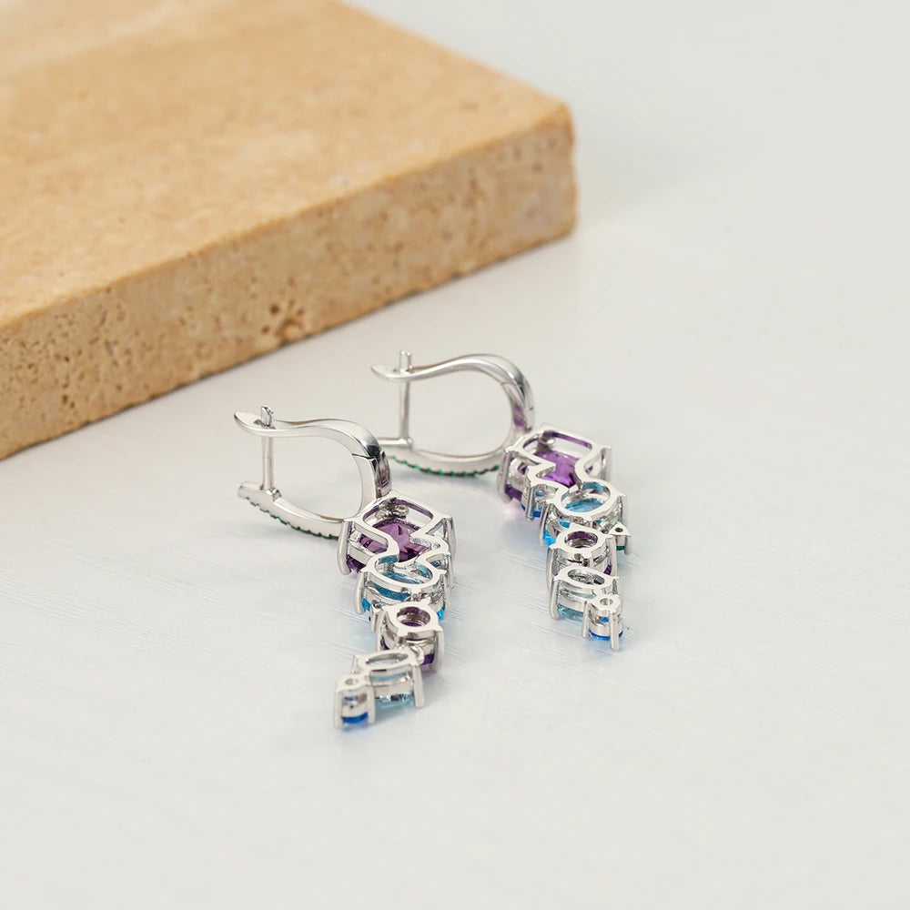 Dangling earrings with gradient blue and green stones set in silver

