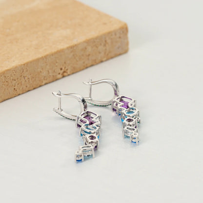 Dangling earrings with gradient blue and green stones set in silver


