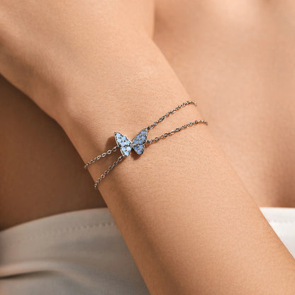 Delicate silver bracelet with a central opal butterfly charm and fine double chain


