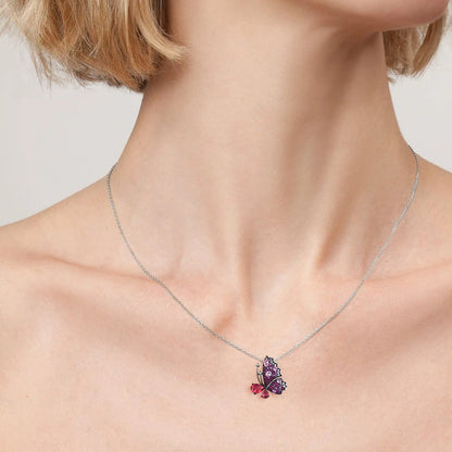 Butterfly ring with sculpted wings in pink and fuchsia gemstones and teardrop-shaped stones forming the body.

