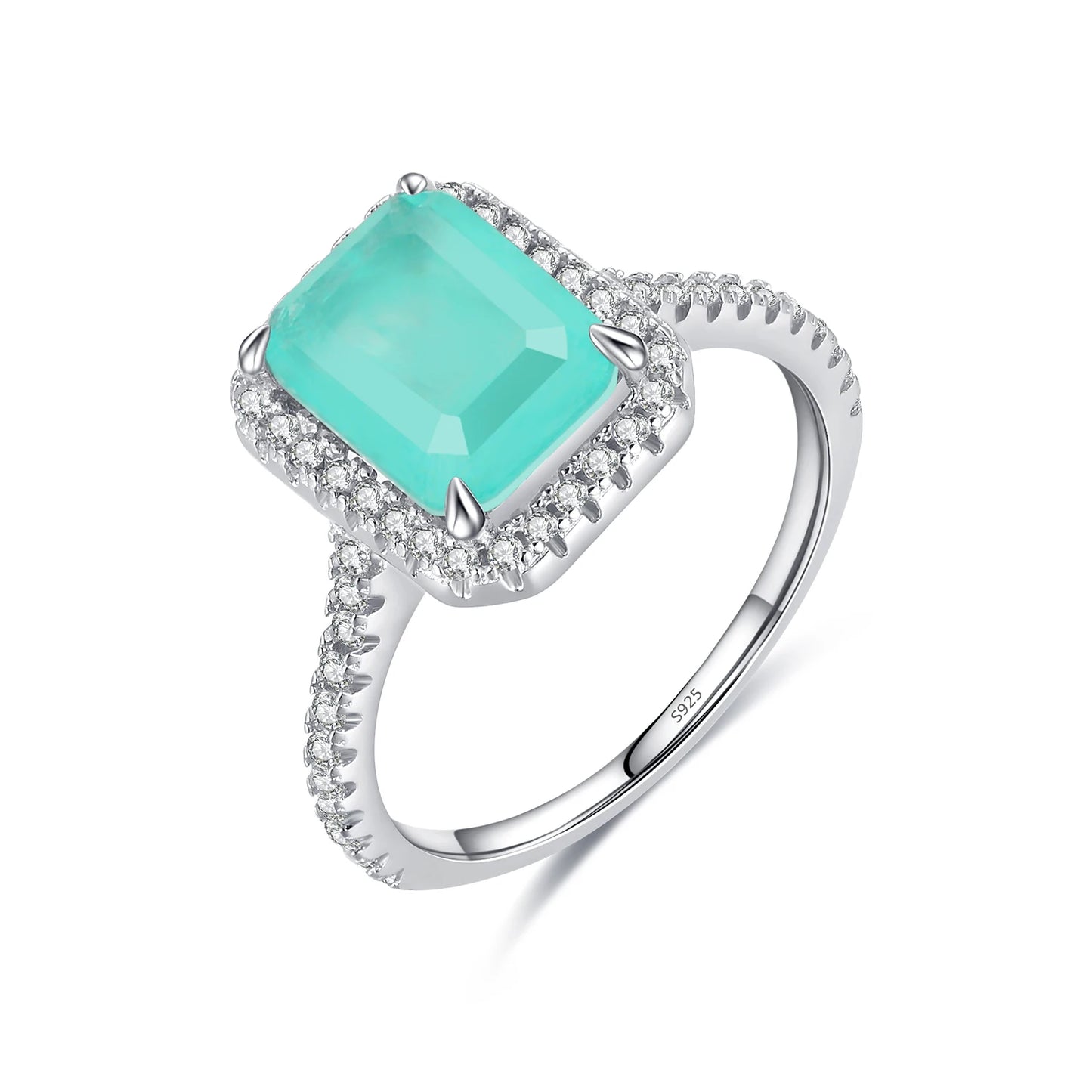 Rectangular green gemstone ring with a halo of clear stones on a silver band.

