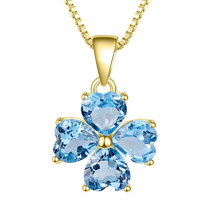 Silver pendant featuring four heart-cut light blue stones arranged in a floral shape


