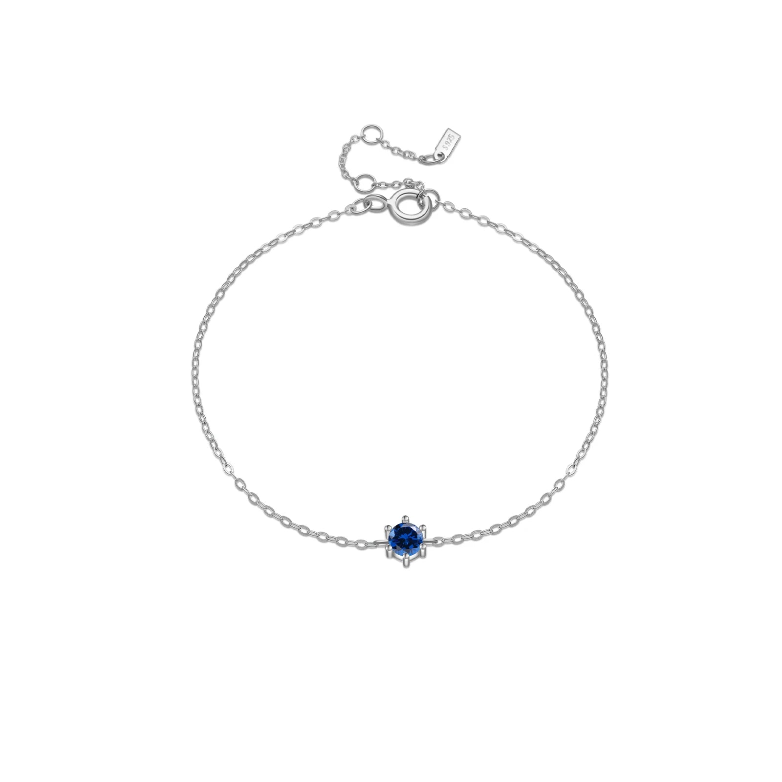 Delicate silver chain bracelet with a single round deep blue gemstone in a minimalist prong setting