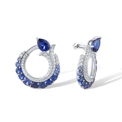 Sterling silver hoop earrings with pavé and deep blue pear-shaped sapphires.

