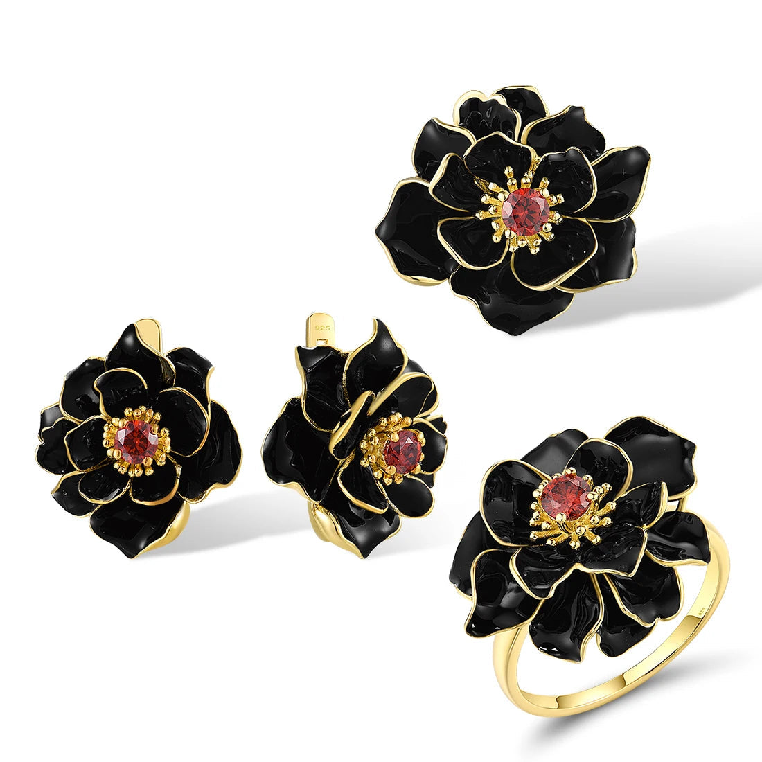 Jewelry set with black enamel floral design and red gemstone center, including a ring, earrings, and pendant.

