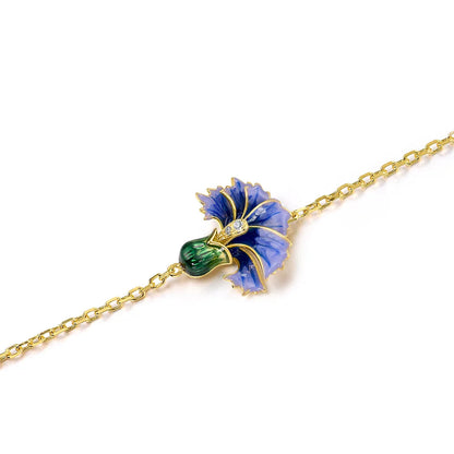 Gold bracelet with a purple and green enamel flower, detailed with sparkling stones on a fine chain

