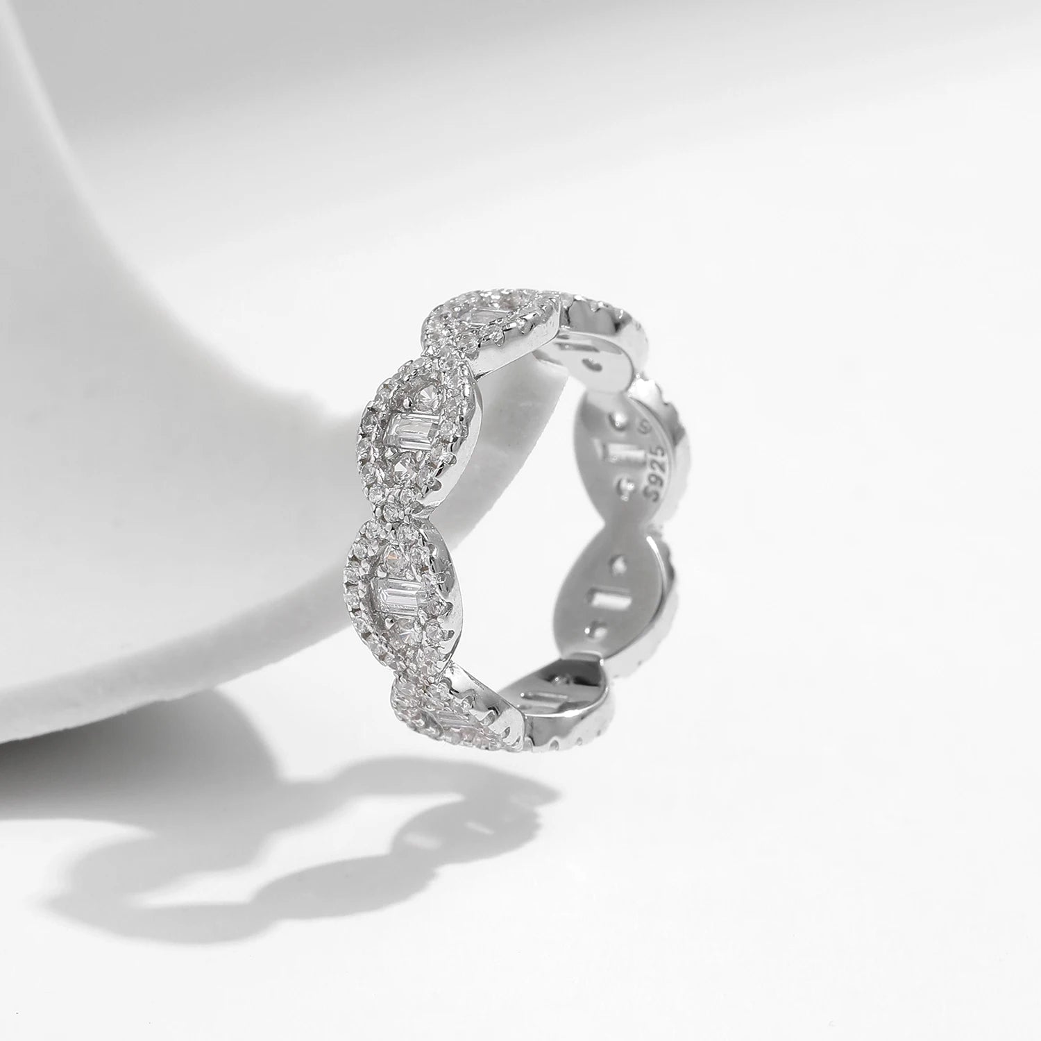 Silver eternity band with scalloped edges and baguette-cut cubic zirconia accents

