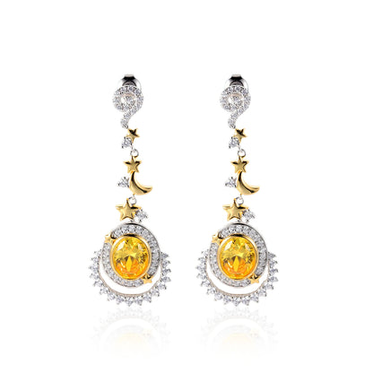 Dangling earrings with yellow gemstones, crescent moons, and star accents in gold and silver

