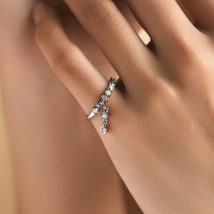 Silver ring with a line of round-cut stones and three delicate cubic zirconia drops