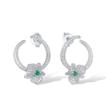 Silver stud earrings with open circle design, pavé stones, and green gemstone floral accents

