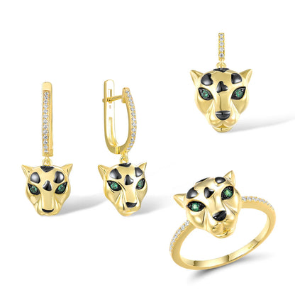 Gold jewelry set featuring panther heads with black spots and green eyes, including earrings, pendant, and ring

