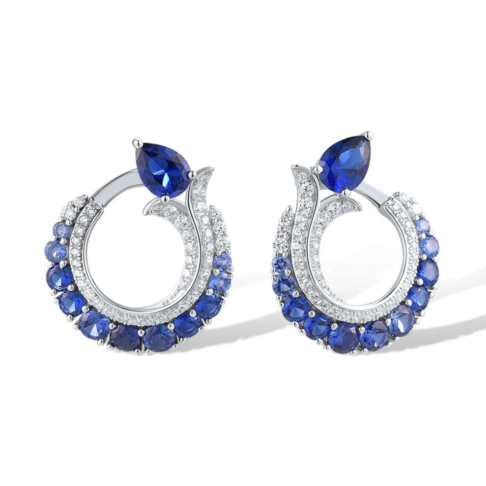 Sterling silver hoop earrings with pavé and deep blue pear-shaped sapphires.

