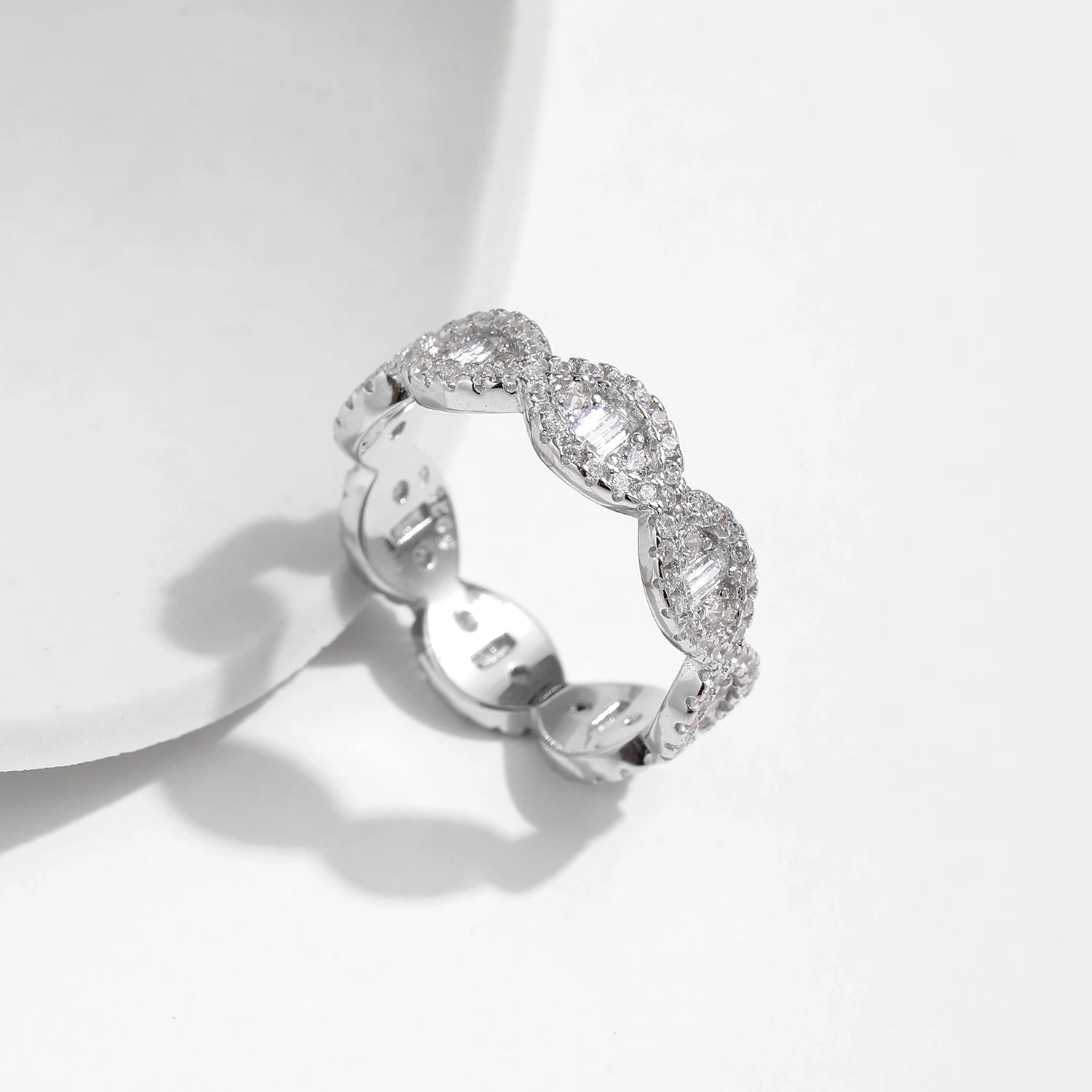 Silver eternity band with scalloped edges and baguette-cut cubic zirconia accents

