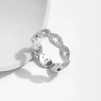 Silver eternity band with scalloped edges and baguette-cut cubic zirconia accents

