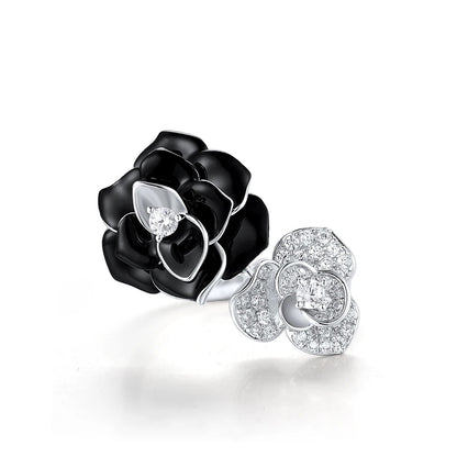 Black and white enamel floral ring with central clear stones in open bypass style


