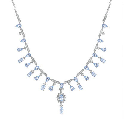 A silver necklace featuring green garnet stones set in an oval pattern with additional small white stones on a link chain.