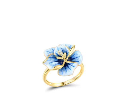 Jewelry set with hand-painted blue flower designs in gold-tone metal, featuring crystal accents

