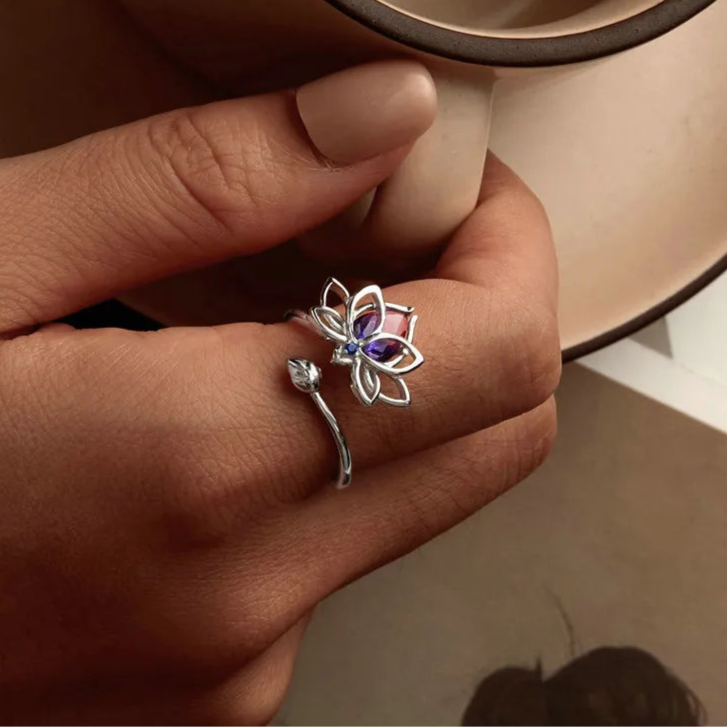 Sterling silver lotus flower ring with pink and blue gradient gemstone and small blue accent stone

