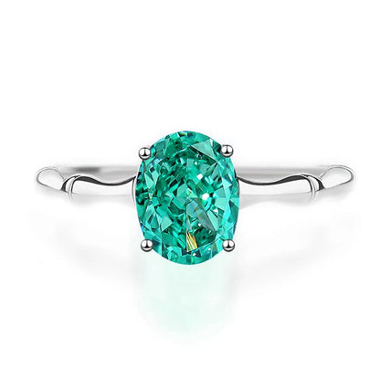 Green oval-cut gemstone ring with a polished silver band and four-prong setting

